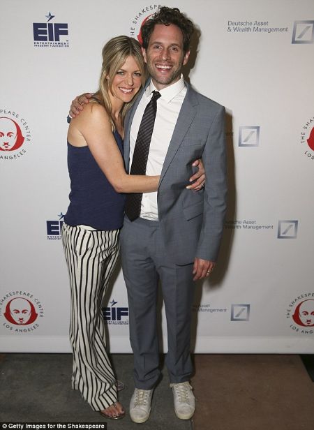 Actor Glenn Howerton in grey suit poses picture with wife Jill Latiano.